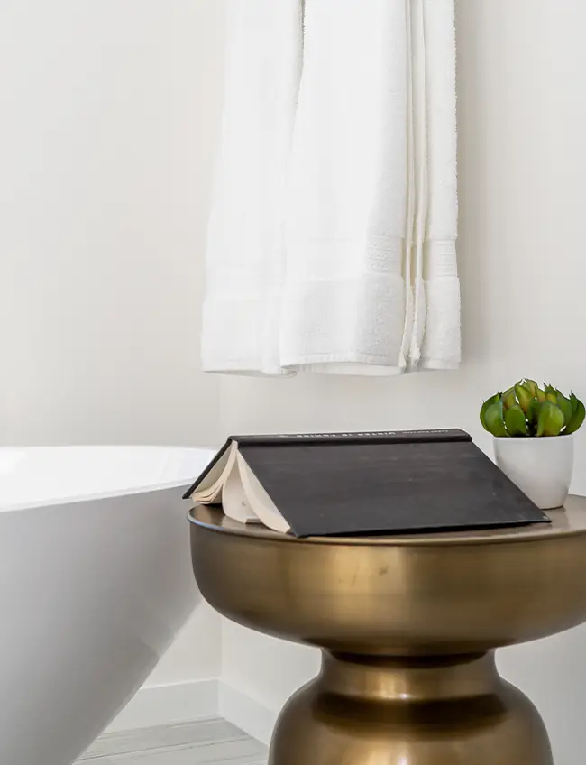 Book on gold table in modern bathroom